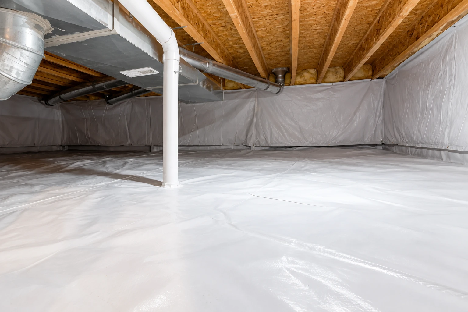 Encapsulated crawl space with white plastic vapor barrier covering the floor and walls beneath exposed joists and ductwork.